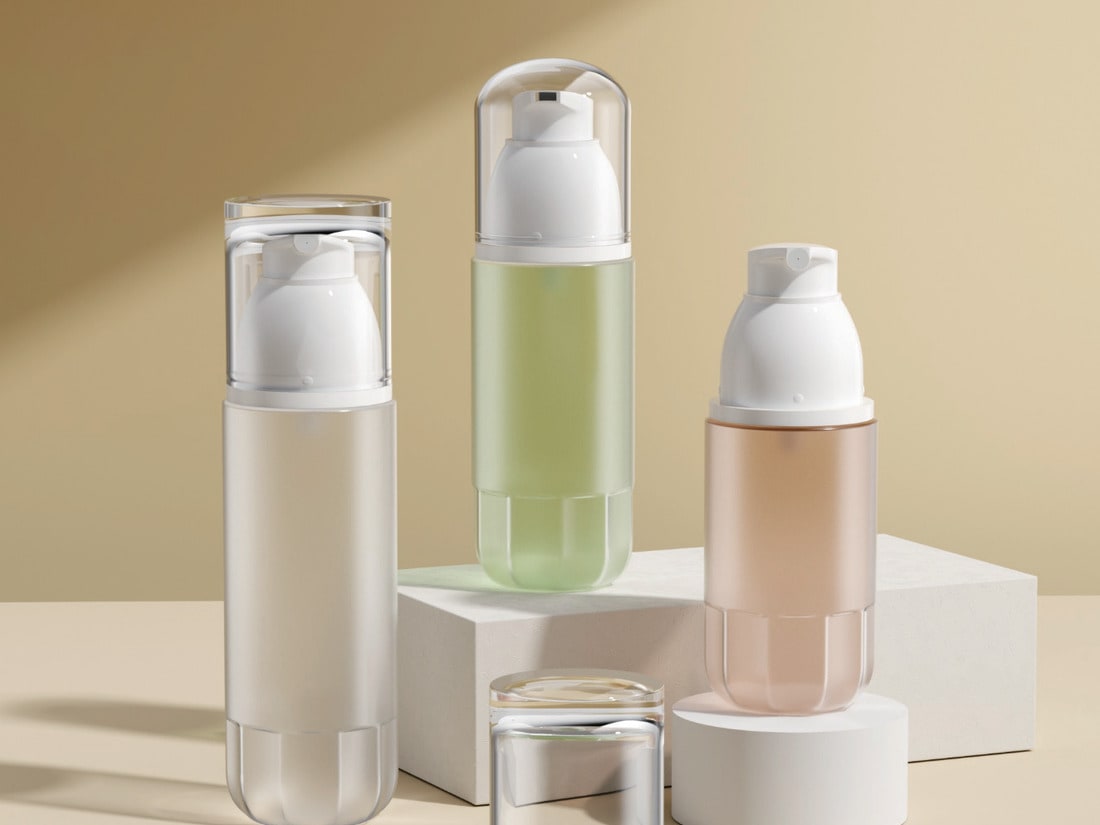 Cream, green and peach airless bottles on a warm neutral set