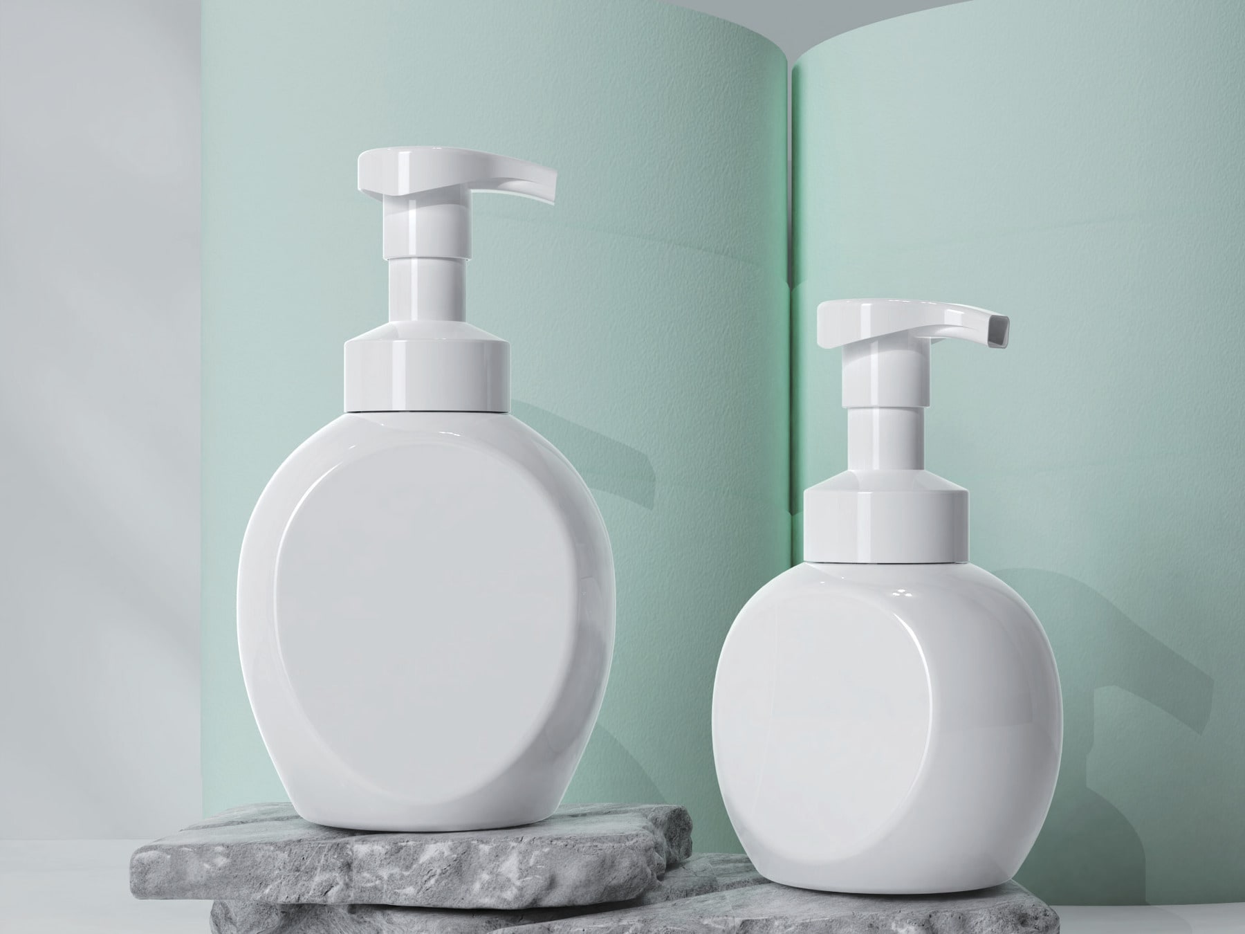 White foaming pump bottles resting on a grey stone plinth